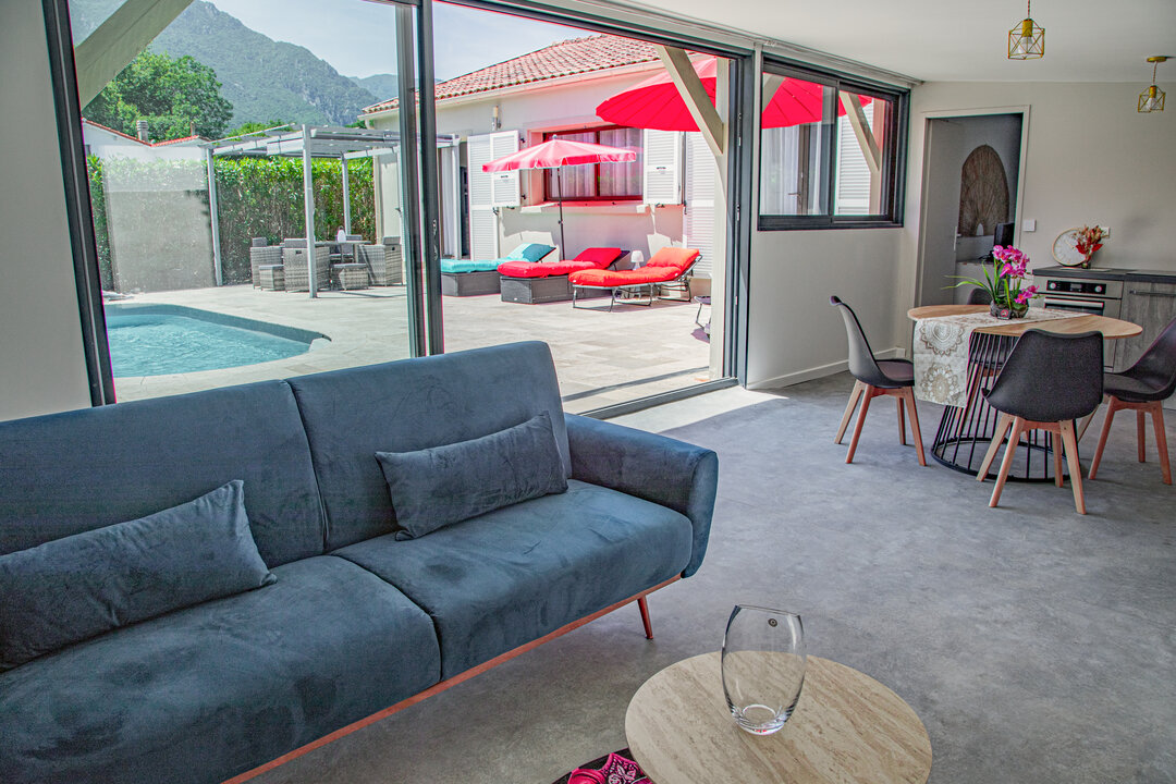 Piscine et terrasse aménagée du jardin clos d'A Casa Serena, avec transats et pergola